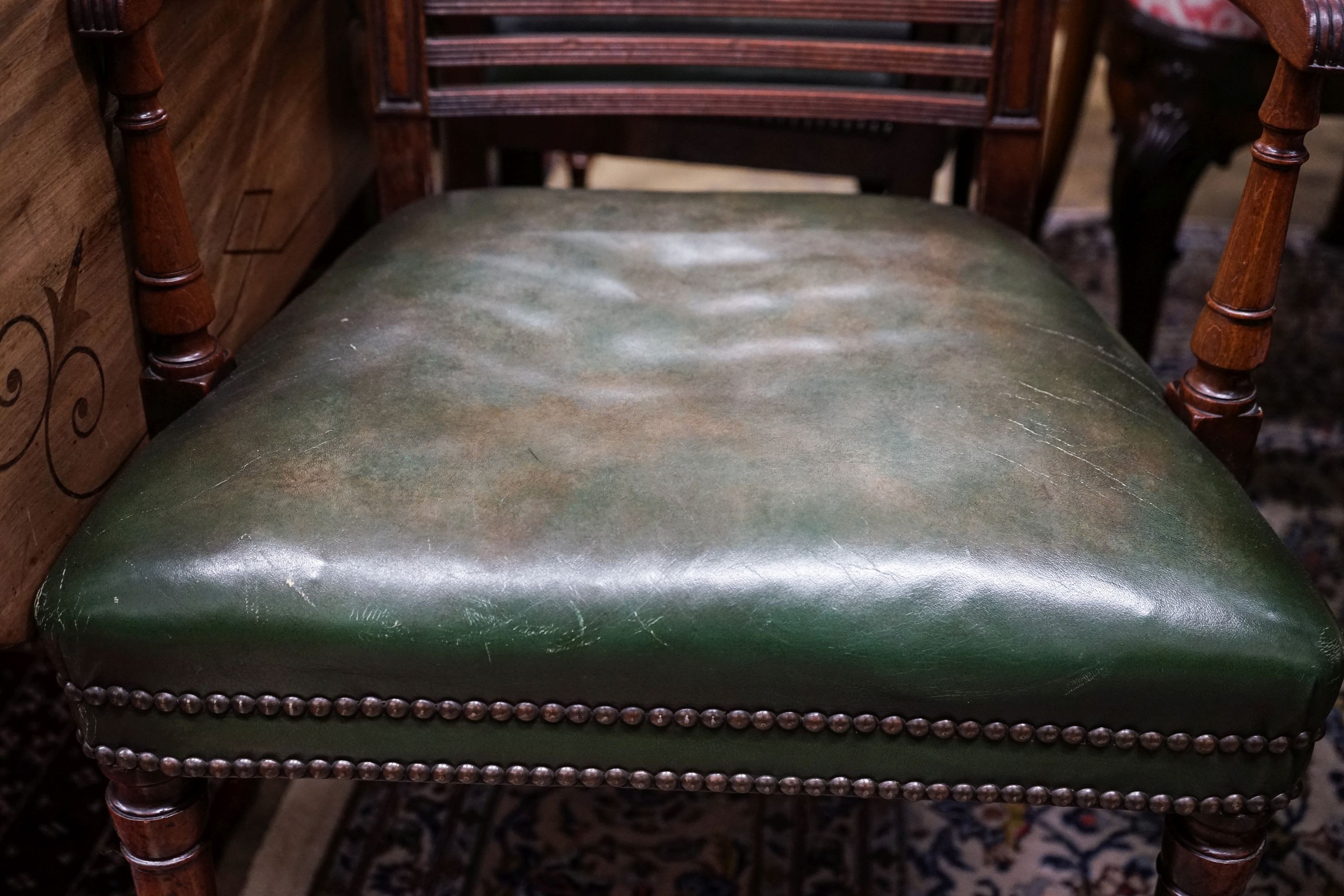 A pair of George III mahogany Sheraton style elbow chairs